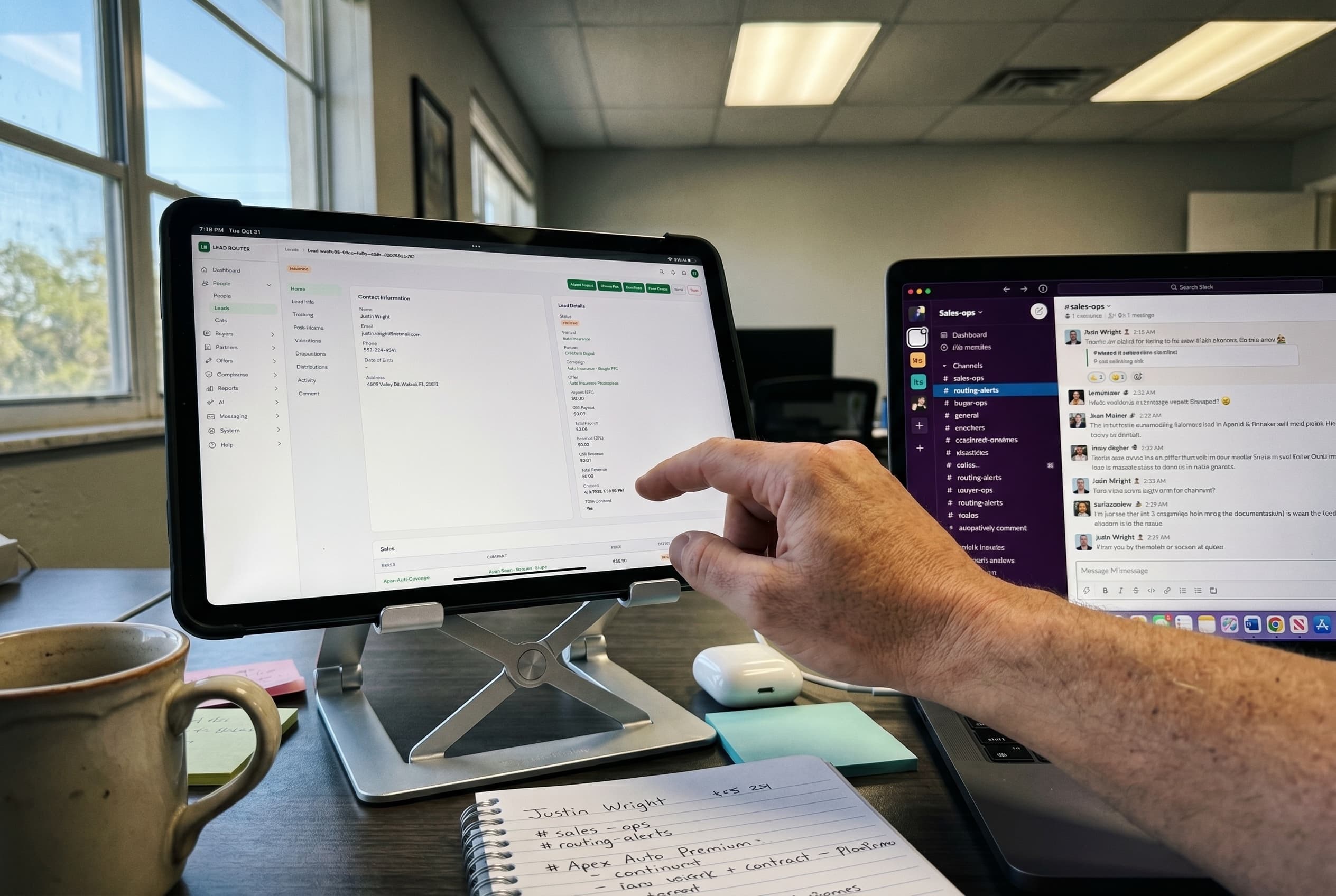 A real working desk with Lead Router on an iPad and Slack open on a laptop alongside it